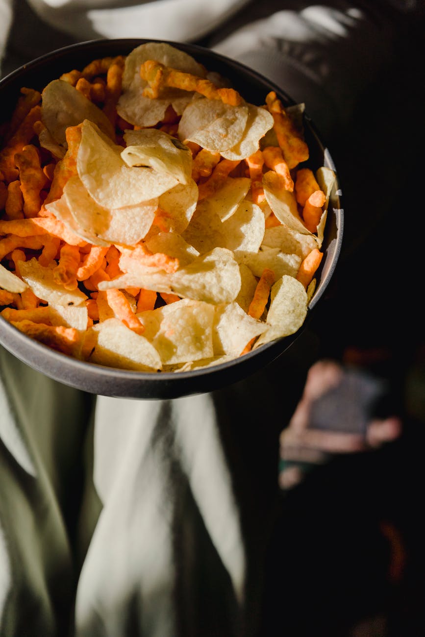 bowl with tasty chips and snacks